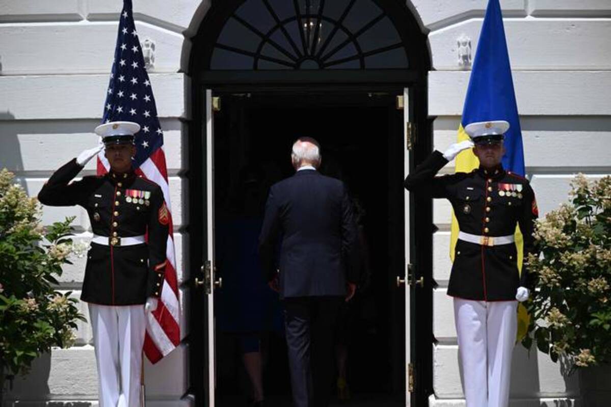 President Biden walks into the White House on Tuesday. (Brendan Smialowski/AFP/Getty Images)
