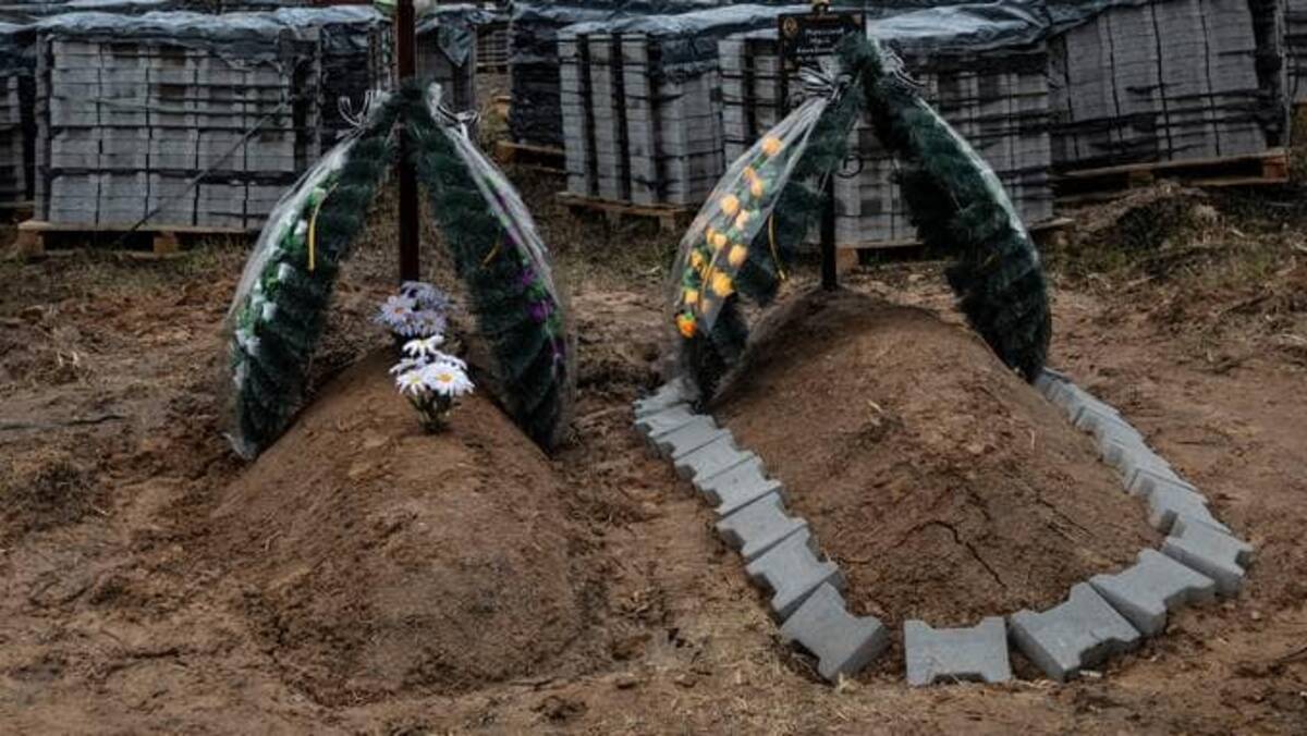 Graves are seen in Bucha, Ukraine nearby a mass grave in the backyard of a church on Tuesday. (Photo by Heidi Levine for The Washington Post).