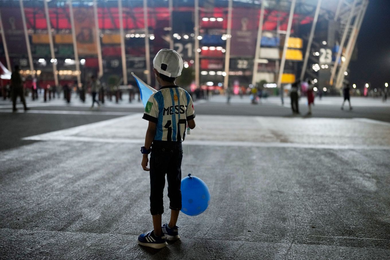 An Argentina soccer fan from India waits outside Stadium 974 before a match between Poland and Argentina in Doha, Qatar. (Natacha Pisarenko/AP)
