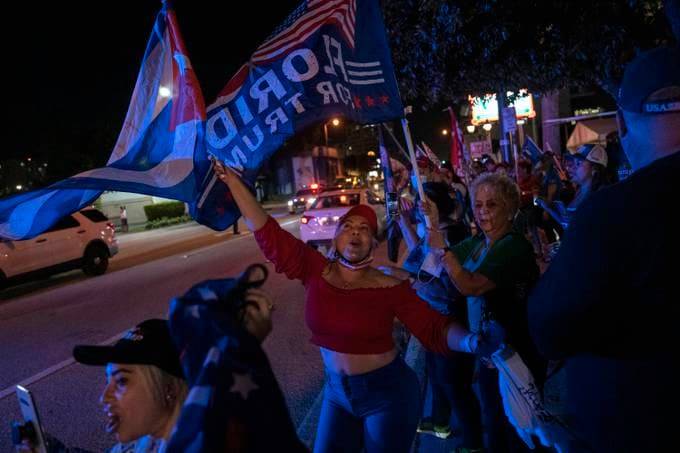 Trump supporters, including Flor de Lis, line Calle Ocho in Miami's Little Havana neighborhood to celebrate his victory in Florida on Nov. 3, 2020. (Michael Robinson Chavez/The Washington Post)