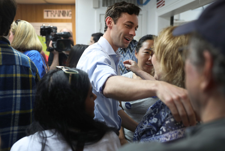Jon Ossoff greets thanks volunteers at a campaign office in Chamblee yesterday. (Joe Raedle/Getty Images)</p>  