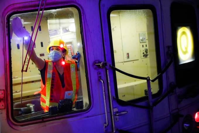 A contractor cleans a subway car in New York. (John Minchillo/Associated Press)