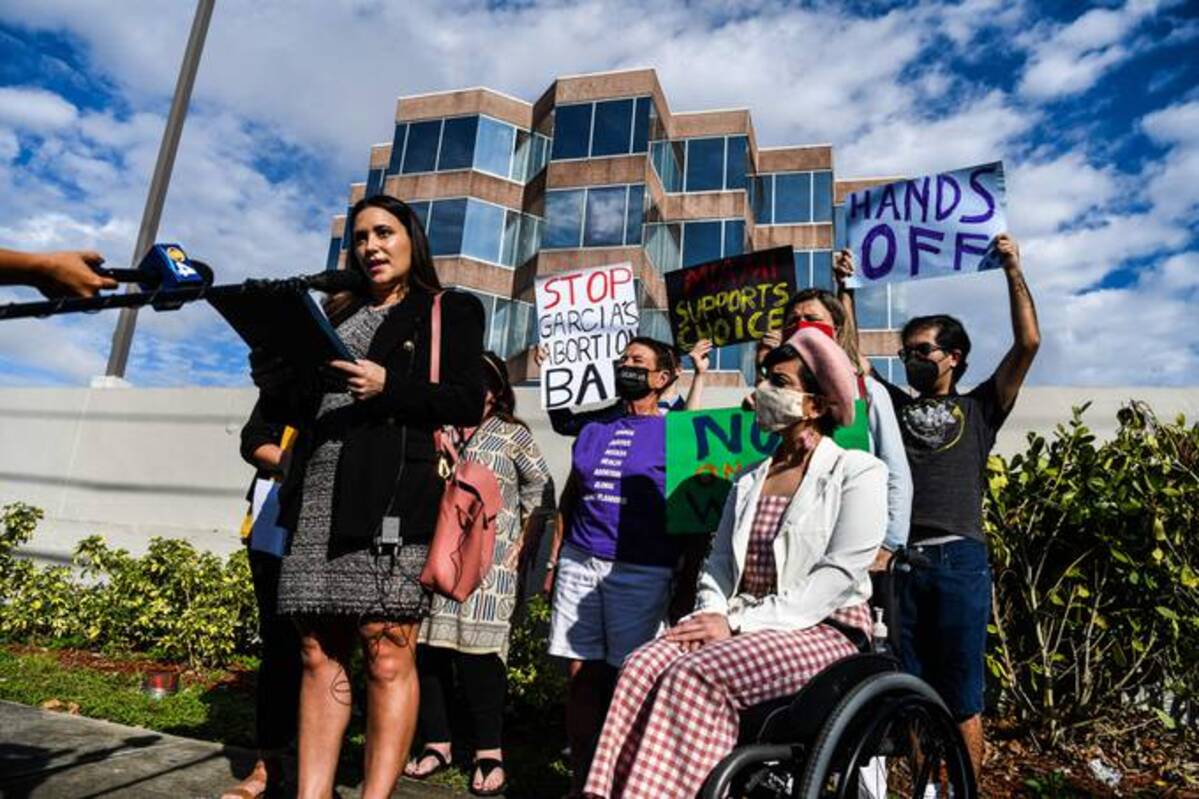 People hold placards as they protest against Florida's 15-week abortion ban in Coral Gables, Florida, on January 21, 2022. (Photo by CHANDAN KHANNA/AFP via Getty Images)