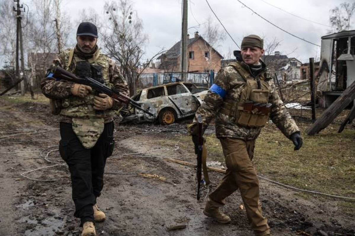 Ukrainian soldiers in destroyed village of Moshchun on Thursday. (Photo by Heidi Levine for The Washington Post).