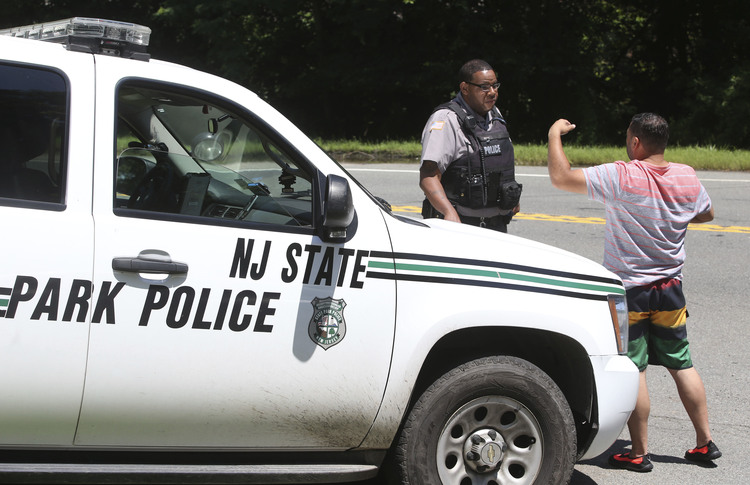 Police block the entrance yesterday to the Bulls Island recreation in Stockton, N.J., as the state government's shutdown dragged into a second day without a resolution to the stalemate between a defiant Chris Christie and an unmoving Democratic Assembly Speaker Vincent Prieto. (Ed Murray/NJ Advance Media via AP)</p>  