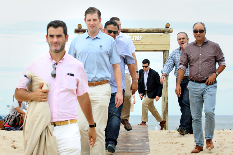 Eric Trump and members of his Secret Service detail walk outside a beachfront restaurant during a private business trip last month to Uruguay. (Cristian Cordoba)</p>