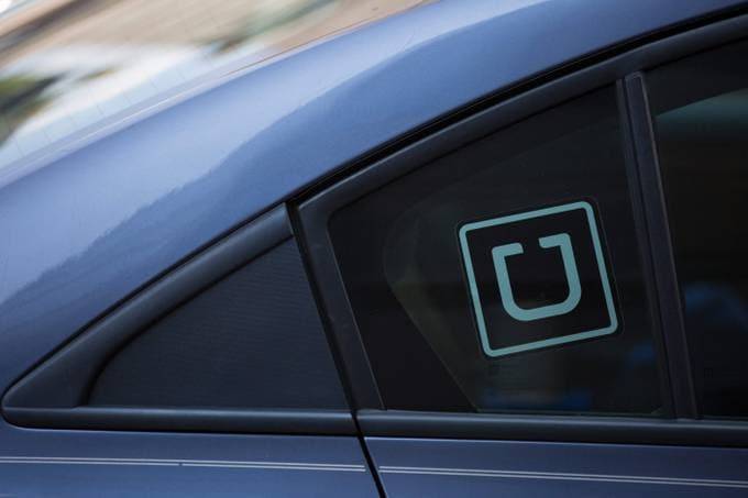 In this file photo the Uber logo is seen on a car in Washington, D.C. (Photo by Alastair Pike / AFP)