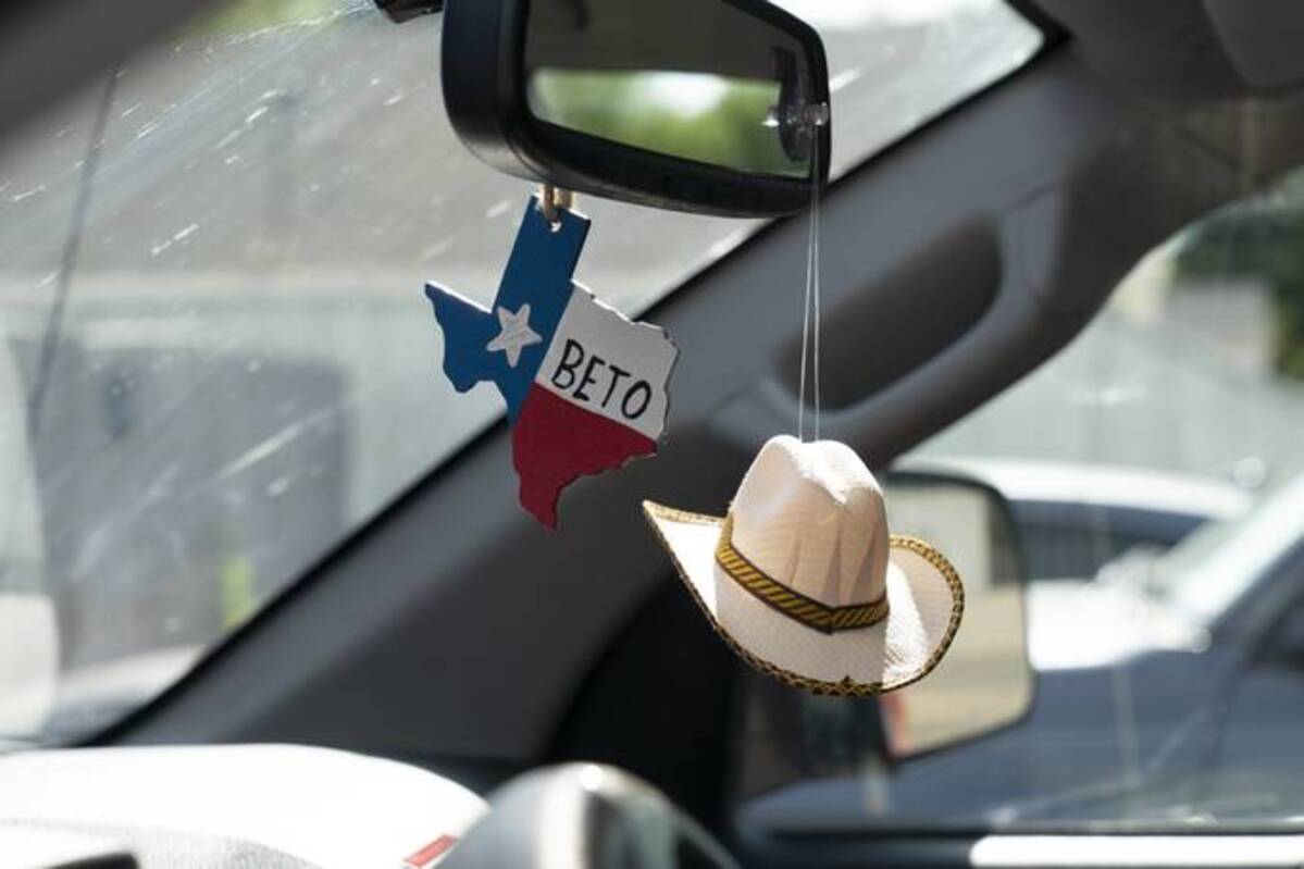 Decorations hang from the rear view vehicle mirror of Texas Democratic gubernatorial candidate Beto O'Rourke in Wichita Falls, Tex., on July 24. (Nick Oxford/The Washington Post)