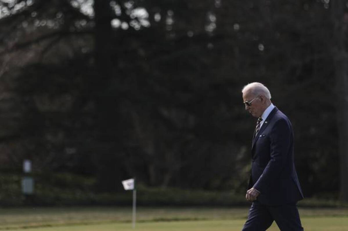 President Biden walks on the South Lawn of the White House before boarding Marine One on Tuesday. (Oliver Contreras/Sipa/Bloomberg News)