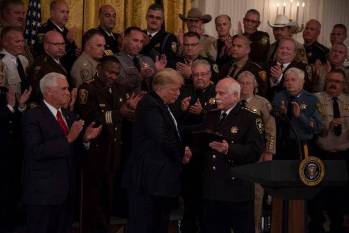 President Donald Trump and Vice President Mike Pence meet with sheriffs from across the country in the East Room of the White House (Calla Kessler/The Washington Post)