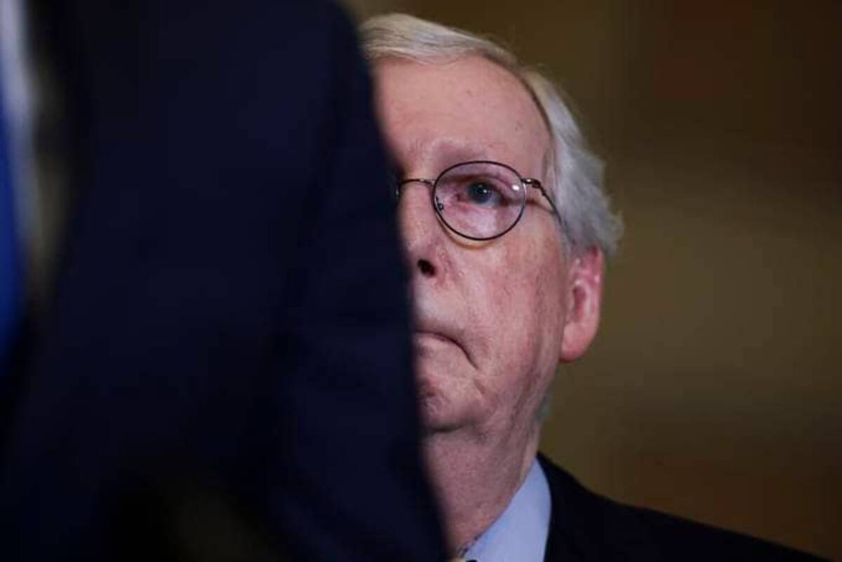 Senate Minority Leader Mitch McConnell (R-Ky.) listens as Senate Minority Whip John Thune (R-S.D.) addresses reporters. (Anna Moneymaker/Getty Images)