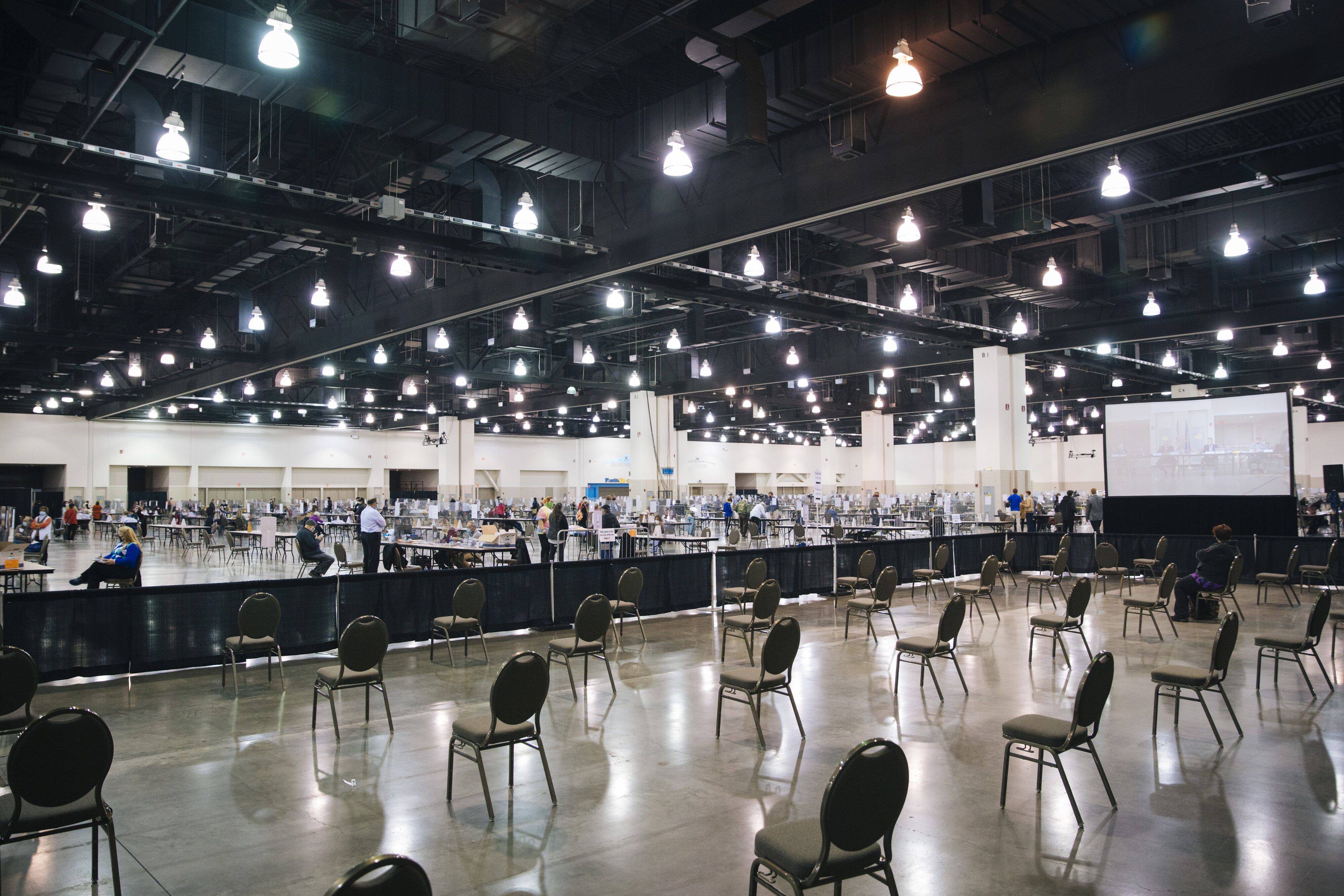 Election workers and official observers work to perform a recount of Milwaukee County's results at the Wisconsin Center on Nov. 20, 2020. (Photo by Taylor Glascock for The Washington Post)