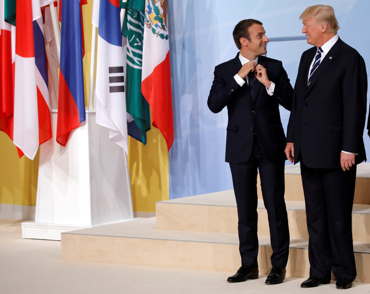 Trump chats with French President Emmanuel Macron before a family photo at the G-20 summit this morning. (Carlos Barria/Reuters)</p>  