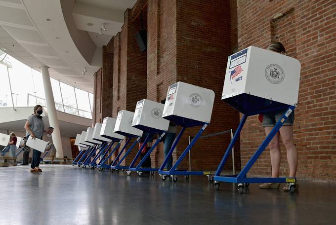 Residents vote during the New York City mayoral primary election at the Brooklyn Museum polling station on Tuesday. (Angela Weiss/AFP/Getty Images)