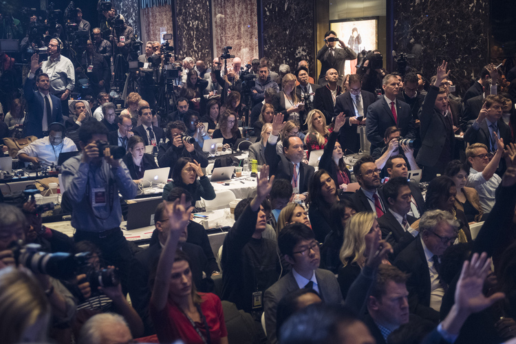 Members of the media raise their hands to try and ask questions during Trump's press conference. (Jabin Botsford/The Washington Post)</p>  