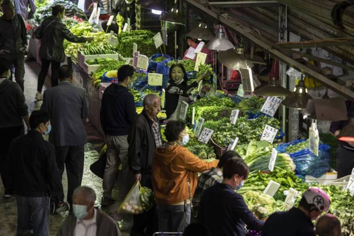 Shoppers browse the vegetables at a market in Shanghai last year. (Qilai Shen/Bloomberg News)