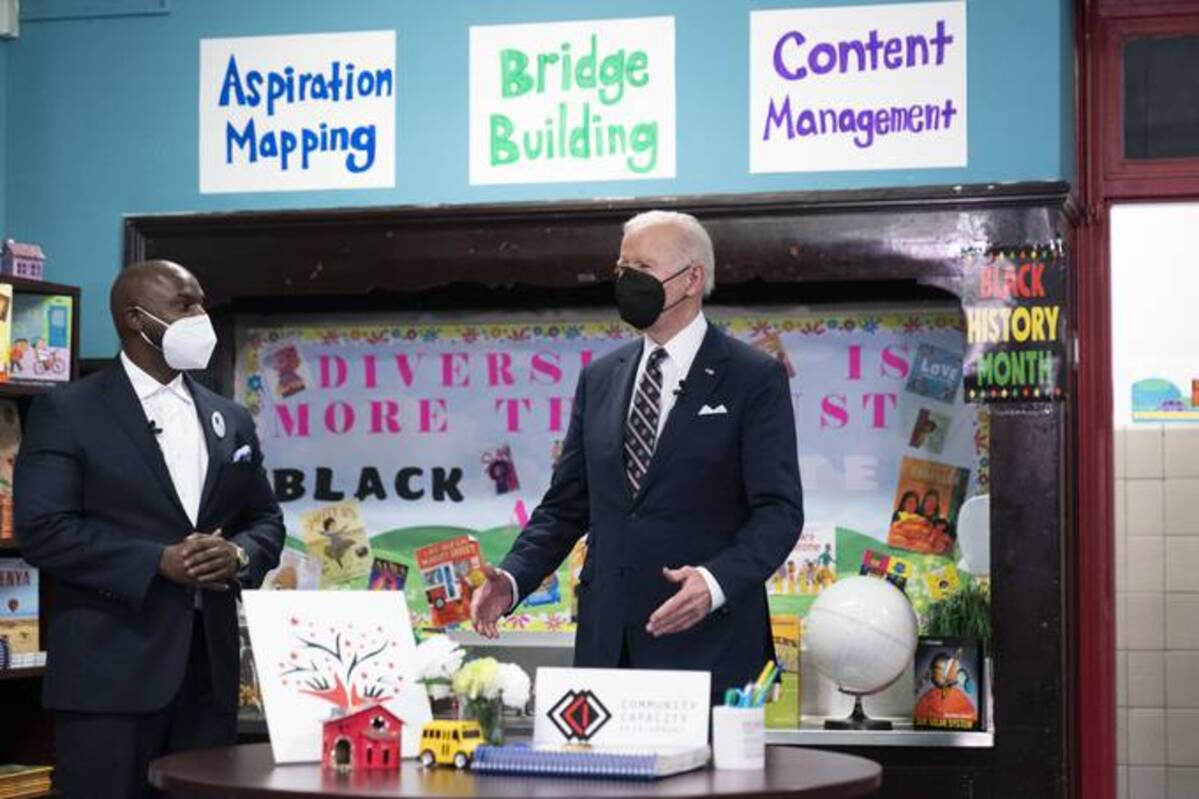 President Biden talks in a classroom with K. Bain of Community Capacity Development for an event on combating gun-violence strategies, at PS111 Jacob Blackwell on Feb. 3. (Alex Brandon/AP)