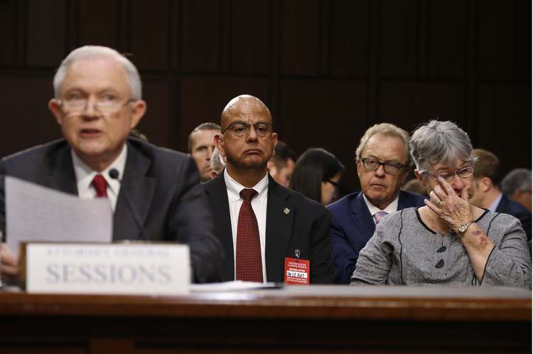 Mary Blackshear Sessions, right, wipes a tear as her husband testifies yesterday. (Jonathan Ernst/Reuters)</p>  