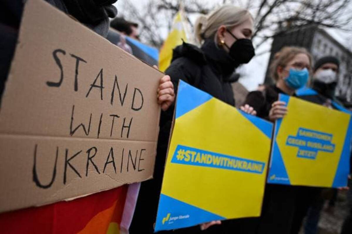 Pro-Ukraine demonstrators display placards during a demonstration in front of the Russian embassy in Berlin on Tuesday. (Photo by JOHN MACDOUGALL/AFP via Getty Images)
