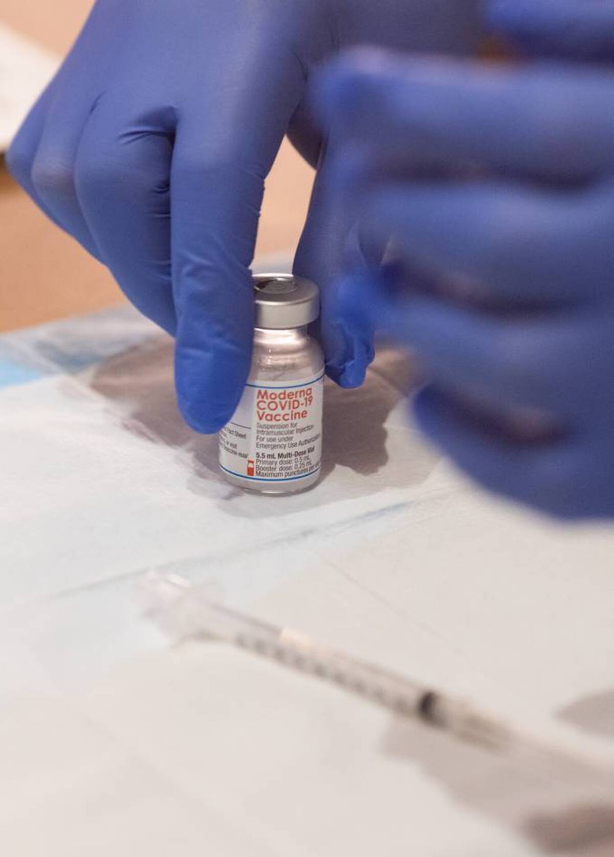 A vial of the Moderna vaccine. (Allison Shelley/The Washington Post)