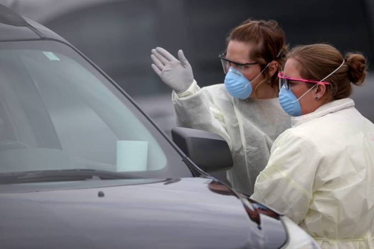 Nurses screened patients at a drive-through testing site in March 2020. (Photo by Win McNamee/Getty Images)