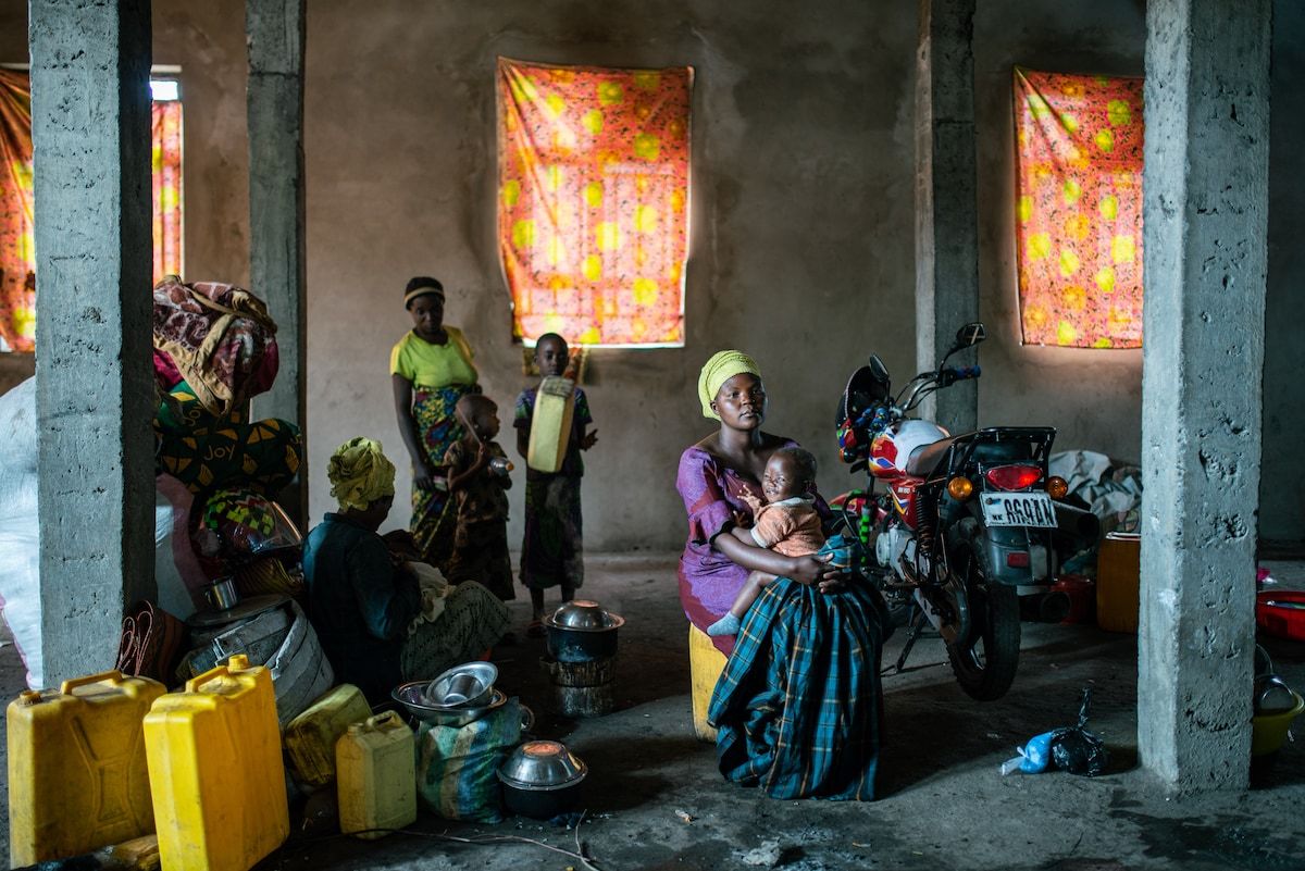 Furaha Mukeshimana, 26, sits at her neighbor's place in the church where they all take refuge from the war in Kanyaruchinya, Democratic Republic of Congo, on Monday. (Arlette Bashizi for The Washington Post)
