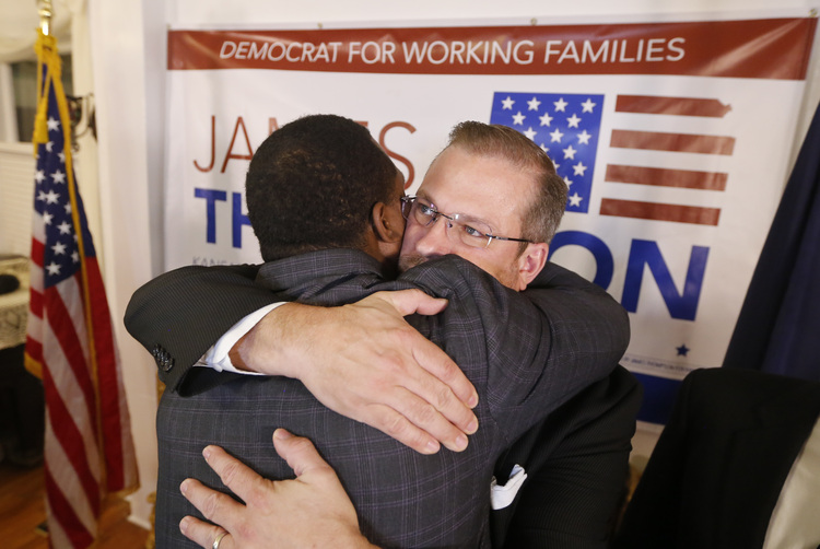 Thompson gets a hug from a supporter at his watch party last night. (Travis Heying/The Wichita Eagle via AP)</p>  