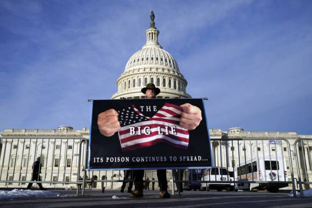 A protestor holds his sign at the Capitol, Thursday, Jan. 6, 2022. (Evan Vucci/AP)