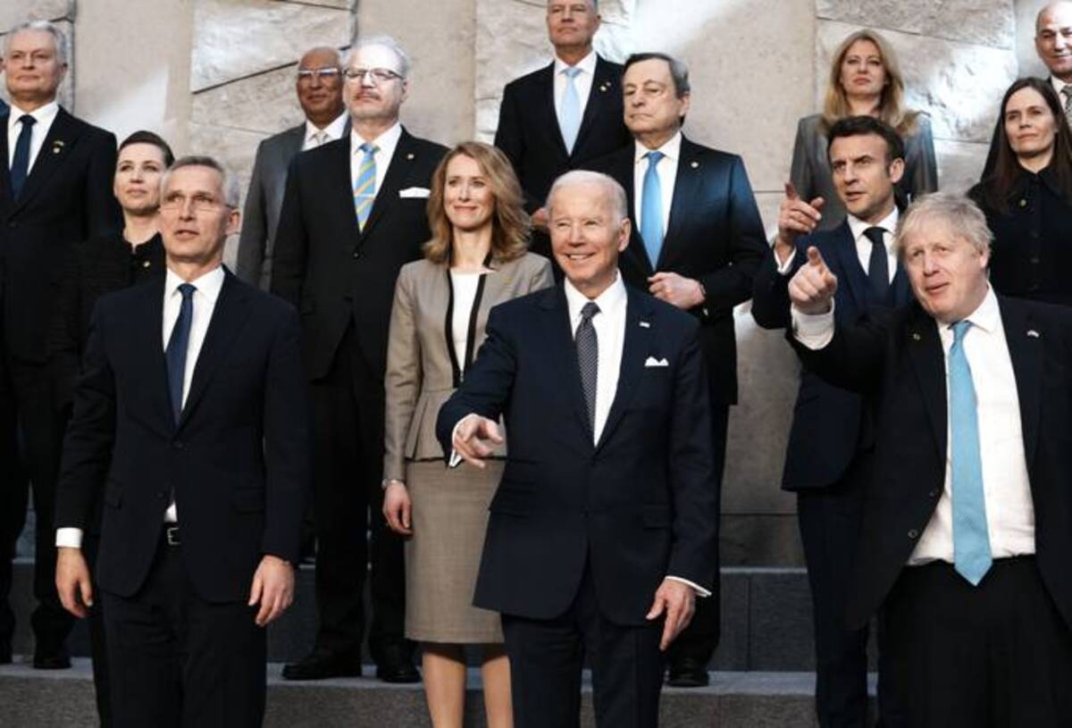 NATO Secretary General Jens Stoltenberg, U.S. President Biden and British Prime Minister Boris Johnson pose during a group photo during a NATO summit at NATO headquarters on Thursday in Brussels. (Thibault Camus/AP)