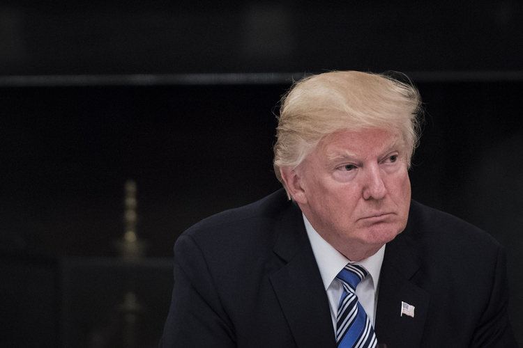 Donald Trump listens yesterday during an American Technology Council roundtable in the State Dinning Room at the White House. (Jabin Botsford/The Washington Post)</p>  