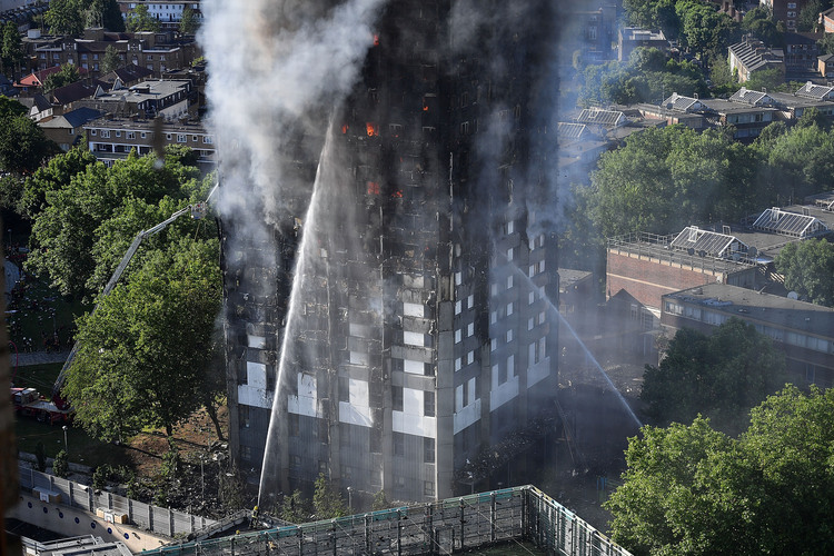 Firefighters tackle a huge fire at&nbsp;Grenfell Tower in Latimer Road, West London, on June 14. (Leon Neal/Getty Images)</p>  