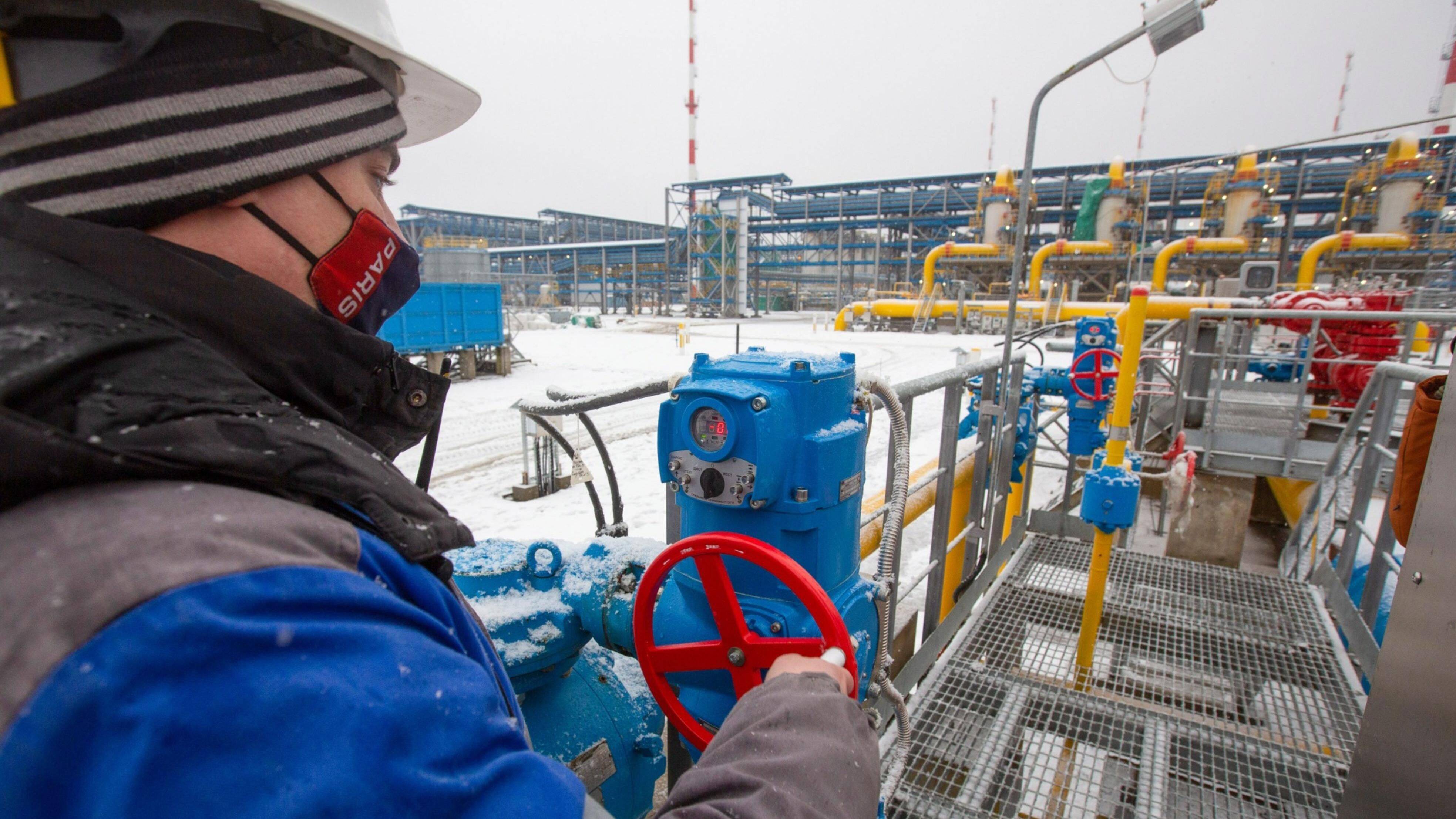A worker adjusts a pipeline valve at the Gazprom PJSC Slavyanskaya compressor station, the starting point of the Nord Stream 2 gas pipeline, in Ust-Luga, Russia in January 2021. (Andrey Rudakov/Bloomberg)