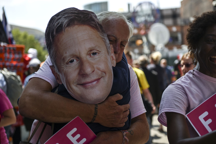 A man embraces a woman wearing a Gary Johnson cutout. Johnson appeared at a CNN town hall event on August 3.&nbsp;(Michael Robinson Chavez/The Washington Post)</p>  