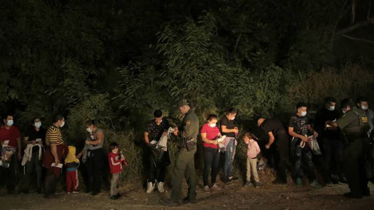 Migrants are lined up and processed by U.S. Border Patrol north in Roma, Tex. (Jason Garza/Reuters)