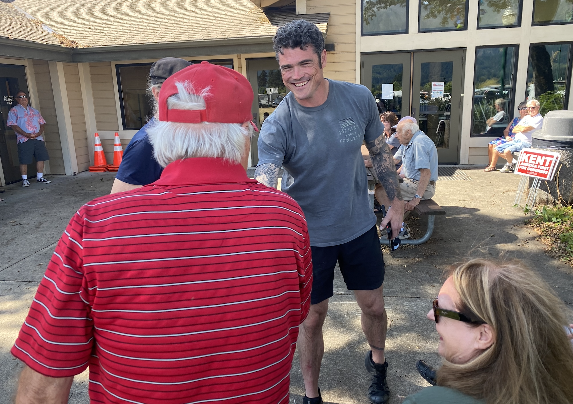 Republican congressional candidate Joe Kent shakes hands before a town hall in Stevenson, Wash., on Sunday. (David Weigel/The Washington Post)