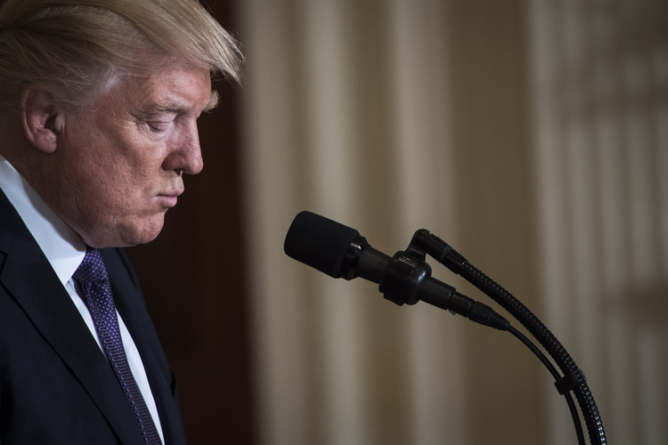 Trump listens during an event in the East Room. (Jabin Botsford/The Washington Post)</p>  