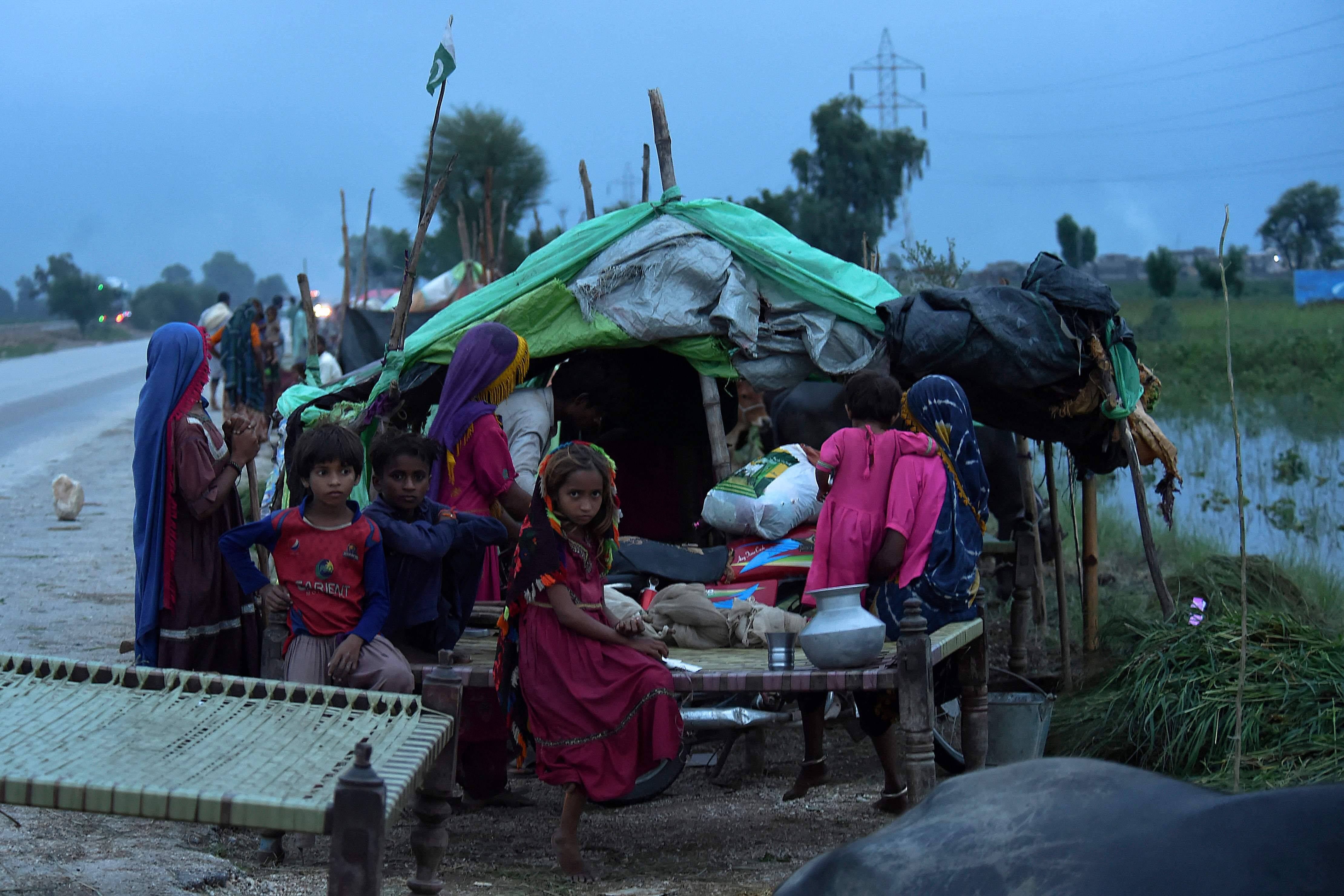 People take shelter at a makeshift camp after heavy monsoon rainfall in Sindh province, southern Pakistan on Aug. 25. (Asif Hassan/AFP via Getty Images)