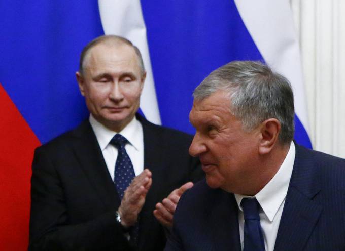 Russian President Vladimir Putin and Rosneft chief executive Igor Sechin attend a signing ceremony following a meeting with the leader of Qatar at the Kremlin in Moscow in 2018. (Sergei Karpukhin/Reuters)