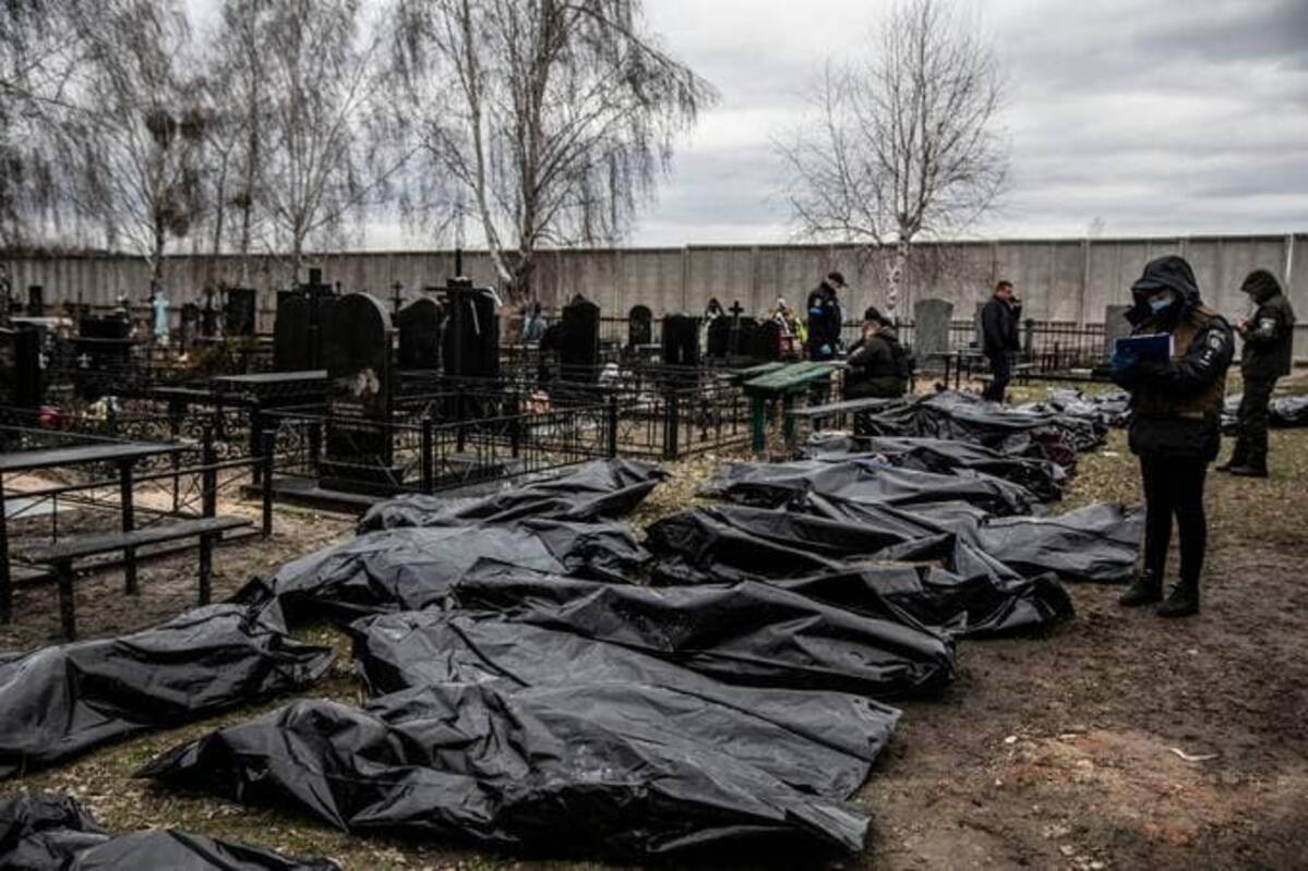 Police officers work in the investigation process following the killing of civilians in Bucha, Ukraine on April 6. (Photo by Heidi Levine for The Washington Post).