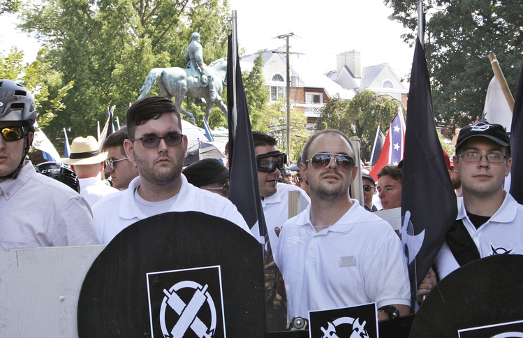 In this photo taken Saturday, James Alex Fields Jr., second from left, holds a black shield in Charlottesville during a white supremacist rally. (Alan Goffinski/AP)  