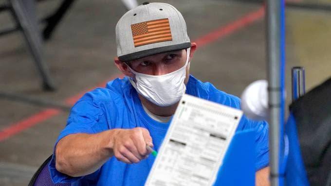Maricopa County ballots are examined and recounted by contractors working for the Florida-based company Cyber Ninjas. (Matt York/Pool/AP)