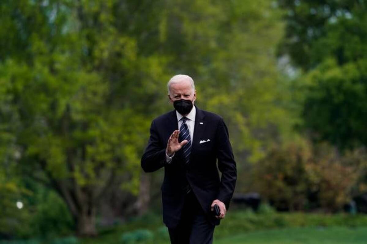 President Biden waves after disembarking from Marine One on the South Lawn at the White House on Sunday. (Elizabeth Frantz/Reuters)