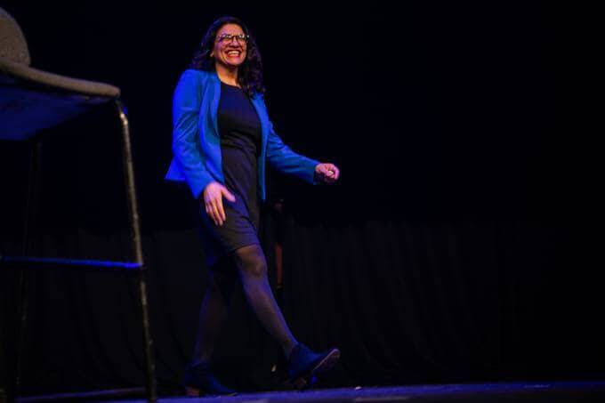 Rep. Rashida Tlaib (D-Mich.) enters the stage during the Bernie Caucus Concert with Bon Iver at Horizon Events Center on Jan. 31, 2020, in Clive, Iowa. (Salwan Georges/The Washington Post)