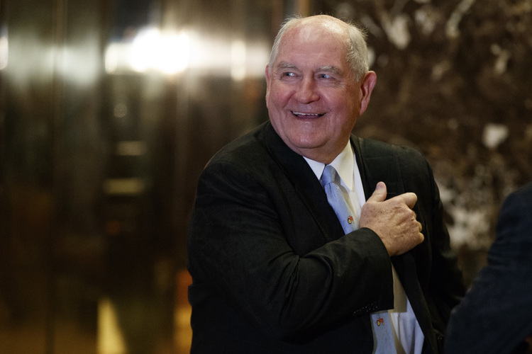 Sonny Perdue waits for an elevator at Trump Tower. (Evan Vucci/AP)</p>  