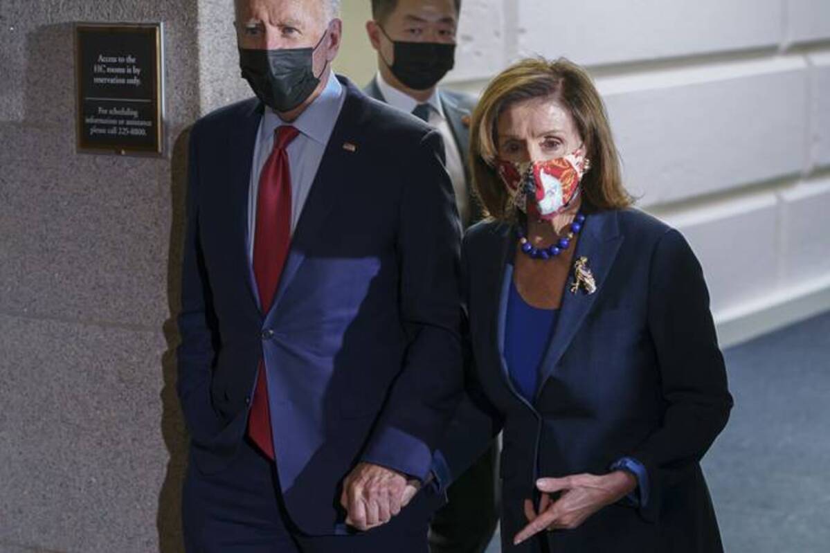 President Biden and Speaker of the House Nancy Pelosi (D-Calif.) walk in a basement hallway of the Capitol after meeting with House Democrats. (AP Photo/J. Scott Applewhite)