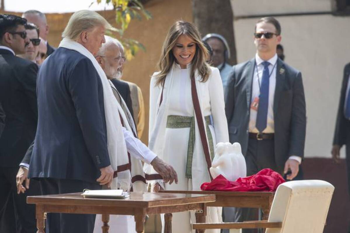 Then- President Donald Trump, with Melania Trump, looks at gift from Indian Prime Minister Narendra Modi, as they tour Gandhi Ashram on Feb. 24, 2020, in Ahmedabad, India. (AP Photo/Alex Brandon)