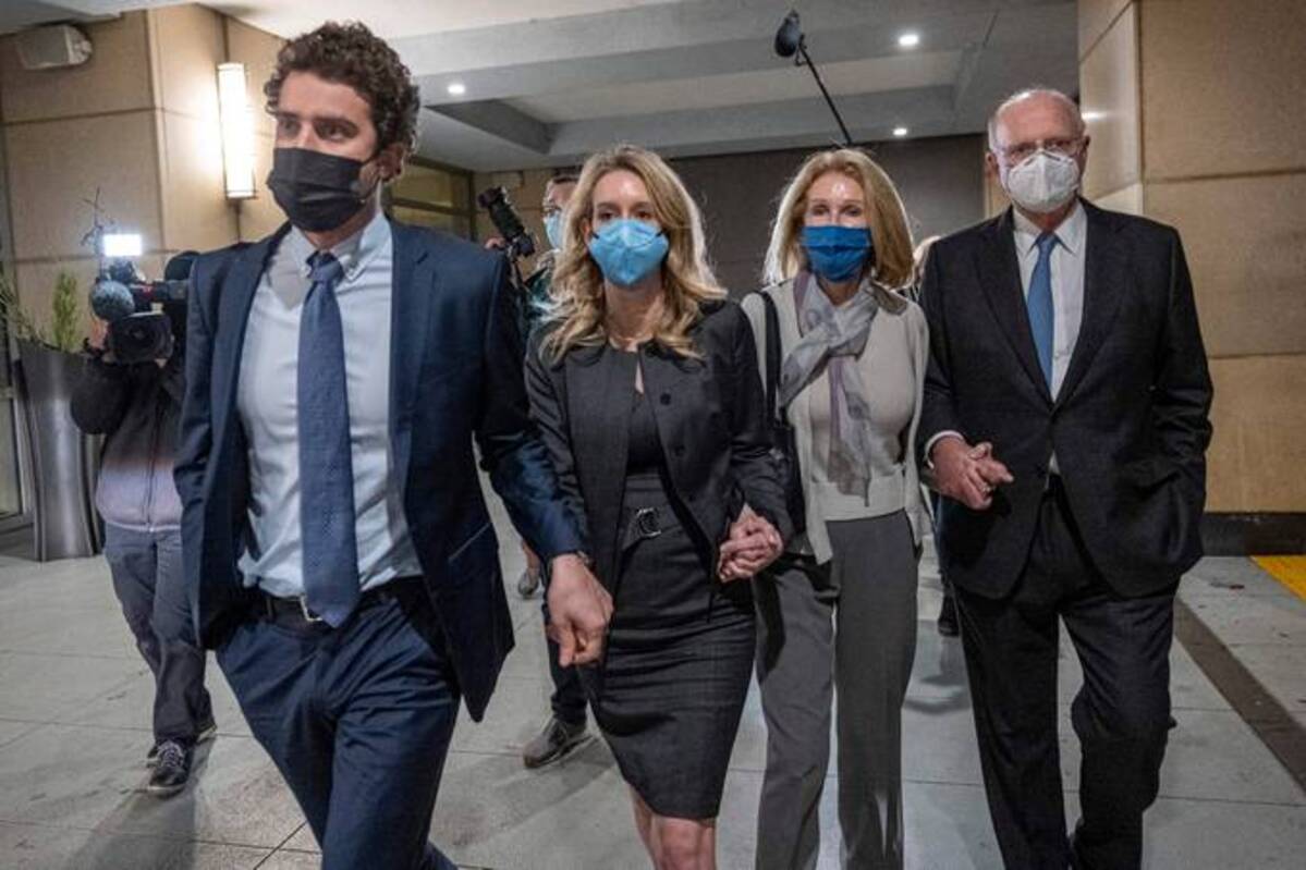 Elizabeth Holmes, left center, departs from federal court with her partner Billy Evans and parents Noel Holmes and Christian Holmes IV in San Jose. (David Paul Morris/Bloomberg News)