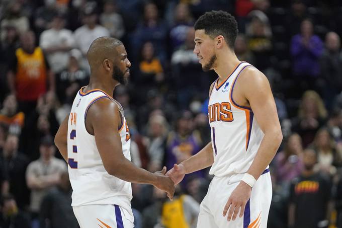 Chris Paul and Devin Booker have led the Phoenix Suns to the NBA's best record. (Rick Bowmer/AP)