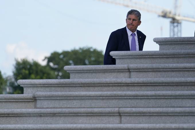 Sen. Manchin walks up the steps of Capitol Hill on Monday. (AP Photo/Susan Walsh)