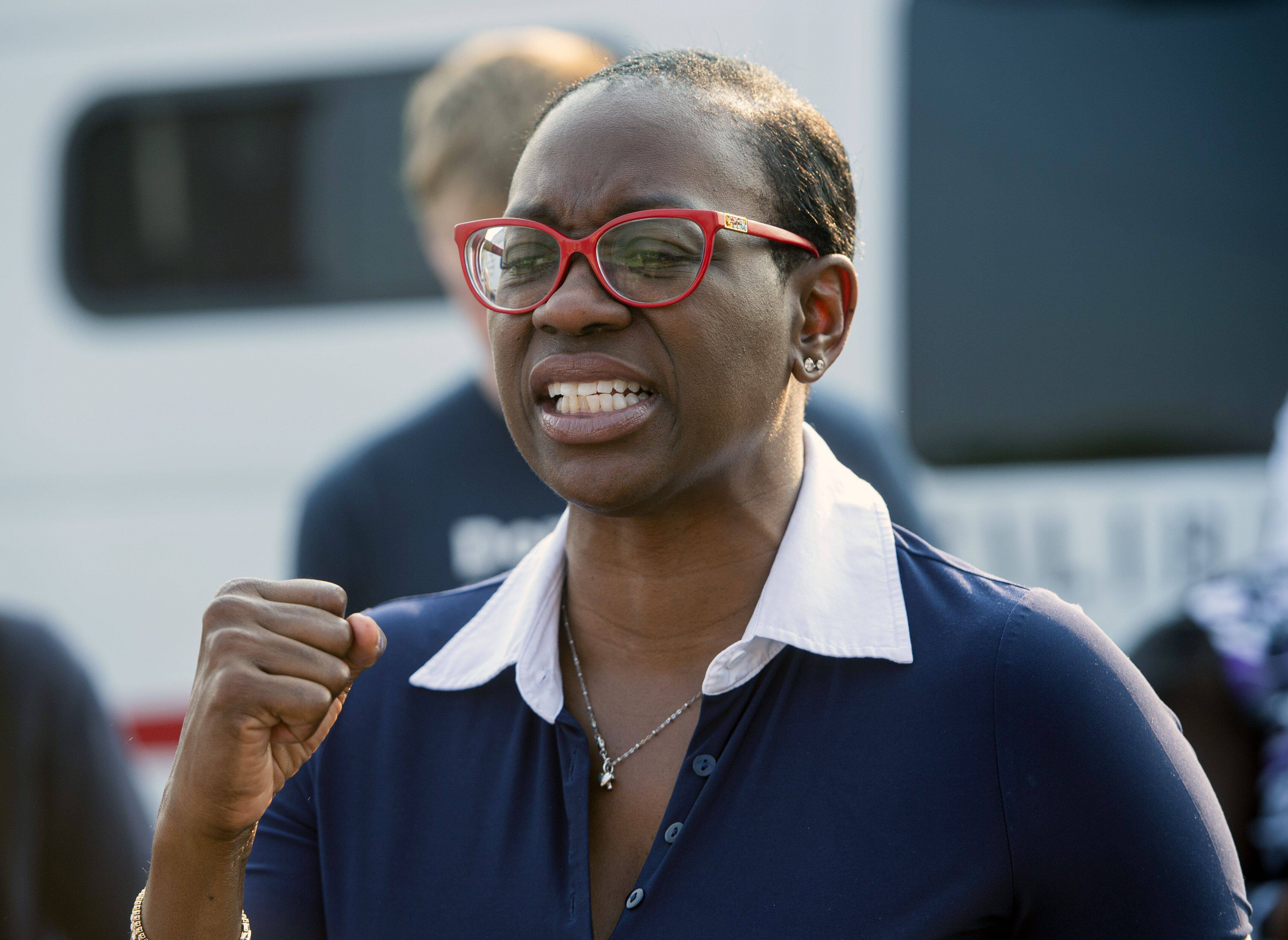Former Ohio state senator Nina Turner speaks with supporters near the Cuyahoga County Board of Elections office in Cleveland on July 7 before casting her vote in a special House election. (Phil Long/AP)